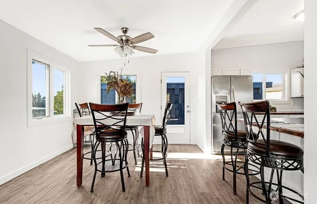 a view of a dining room with furniture and wooden floor
