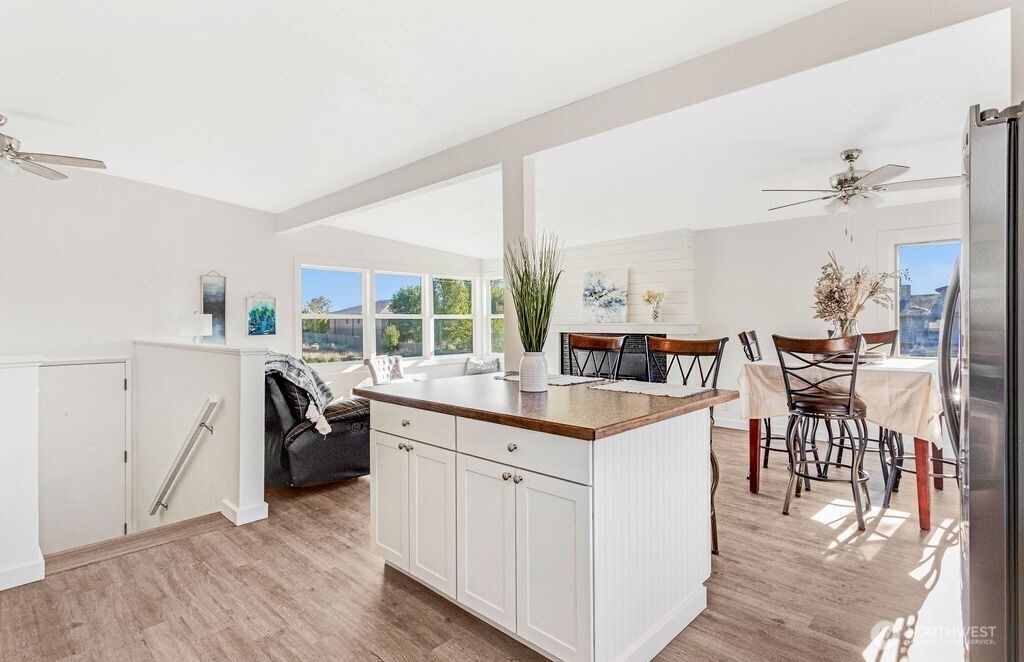 128 West Nelson Road Moses Lake, WA 98837 - Photo 9 of 37 a kitchen with a sink a stove cabinets and wooden floor
