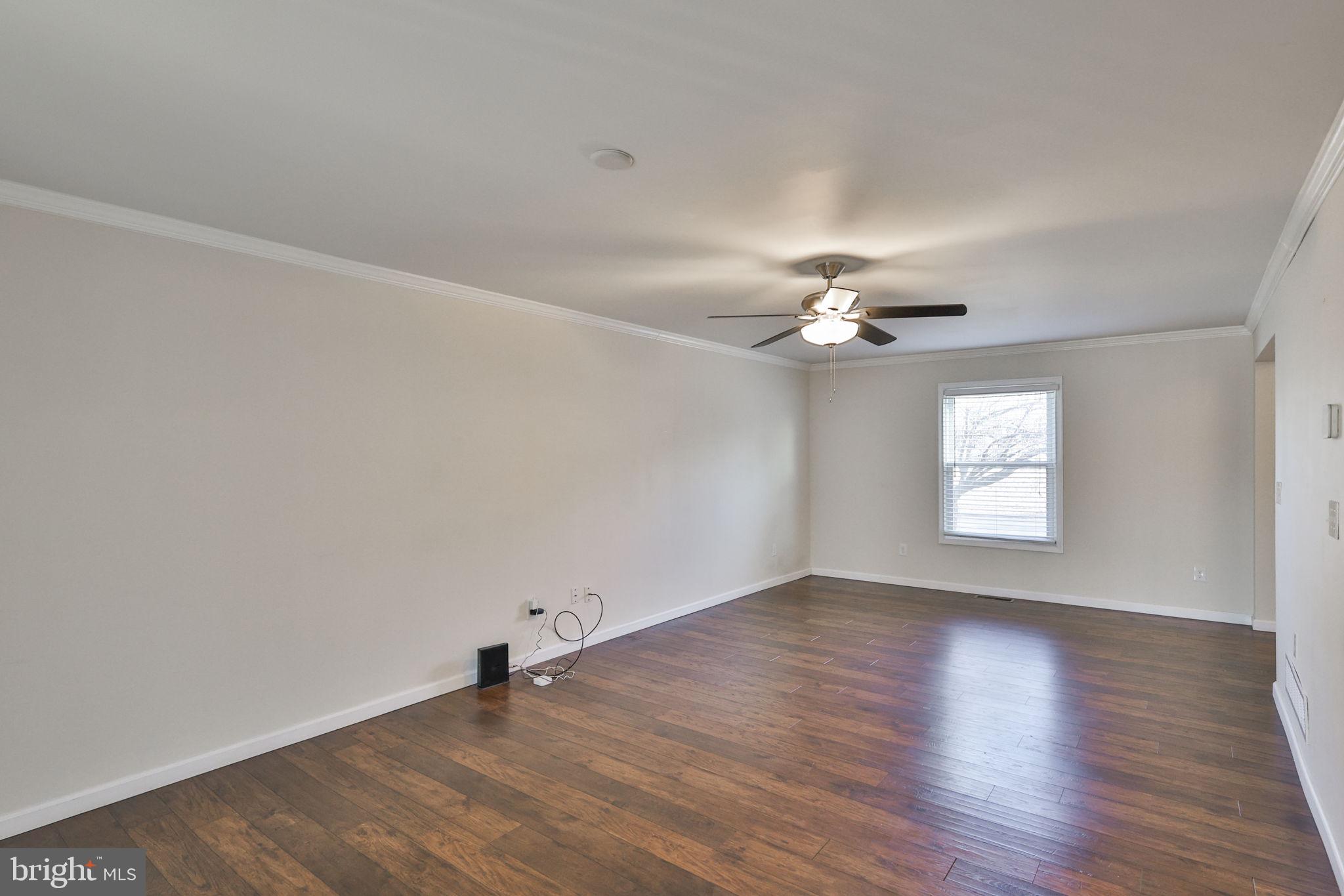 2811 Kingsview Avenue Easton, PA 18045 - Photo 15 of 86 an empty room with wooden floor chandelier fan and windows