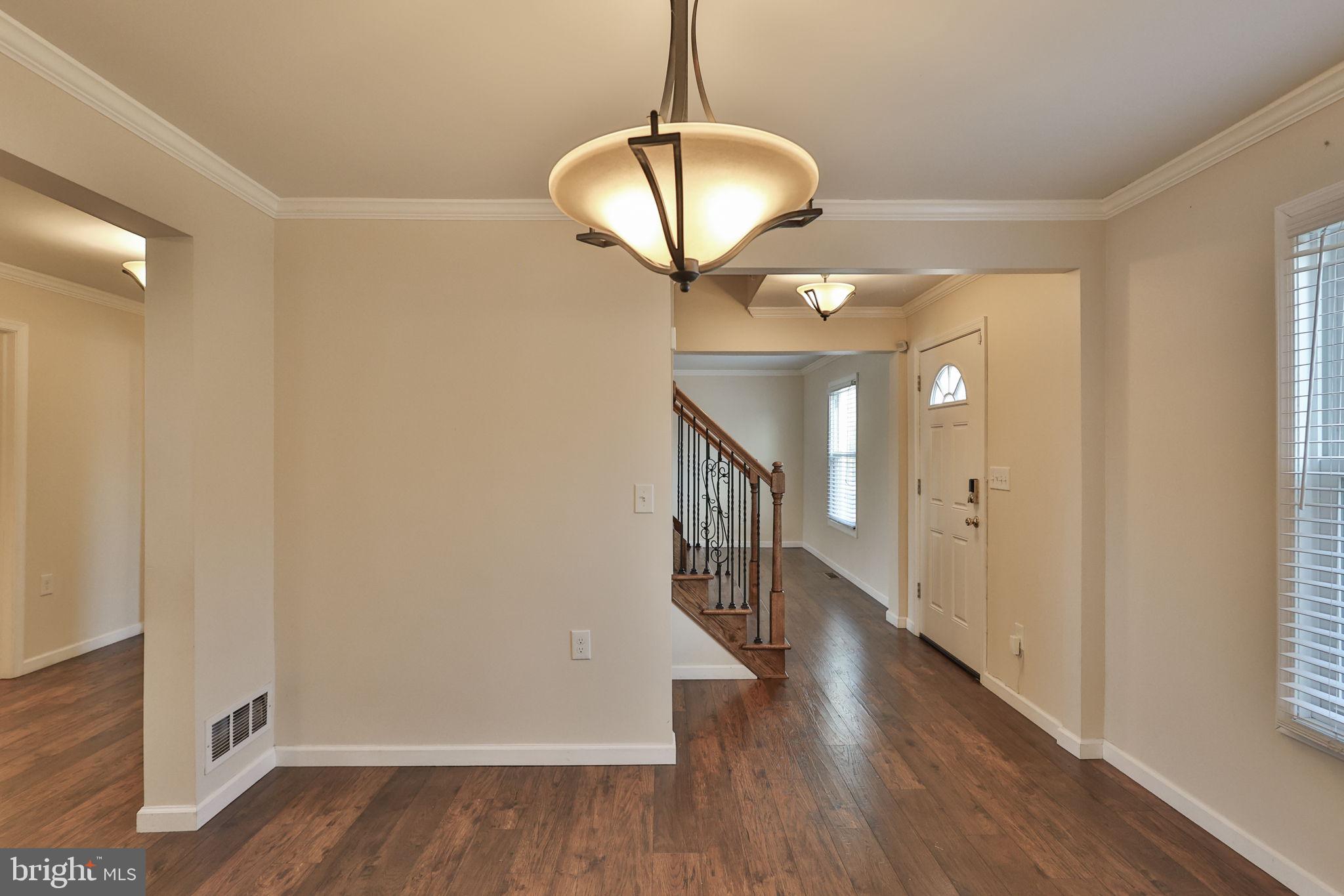 2811 Kingsview Avenue Easton, PA 18045 - Photo 22 of 86 a view of a hallway with wooden floor and chandelier