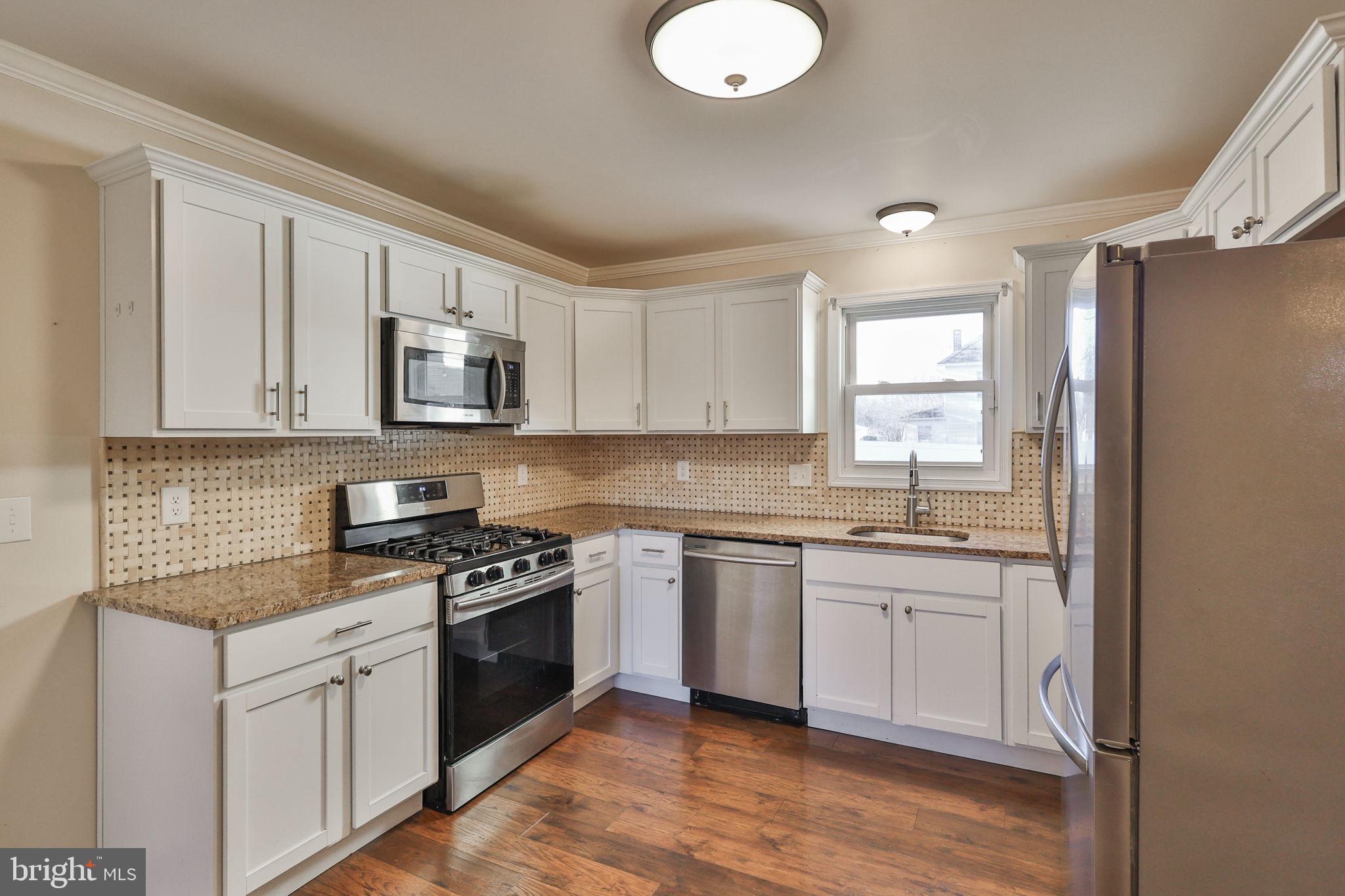 2811 Kingsview Avenue Easton, PA 18045 - Photo 26 of 86 a kitchen with stainless steel appliances granite countertop a sink a stove a refrigerator cabinets and a window