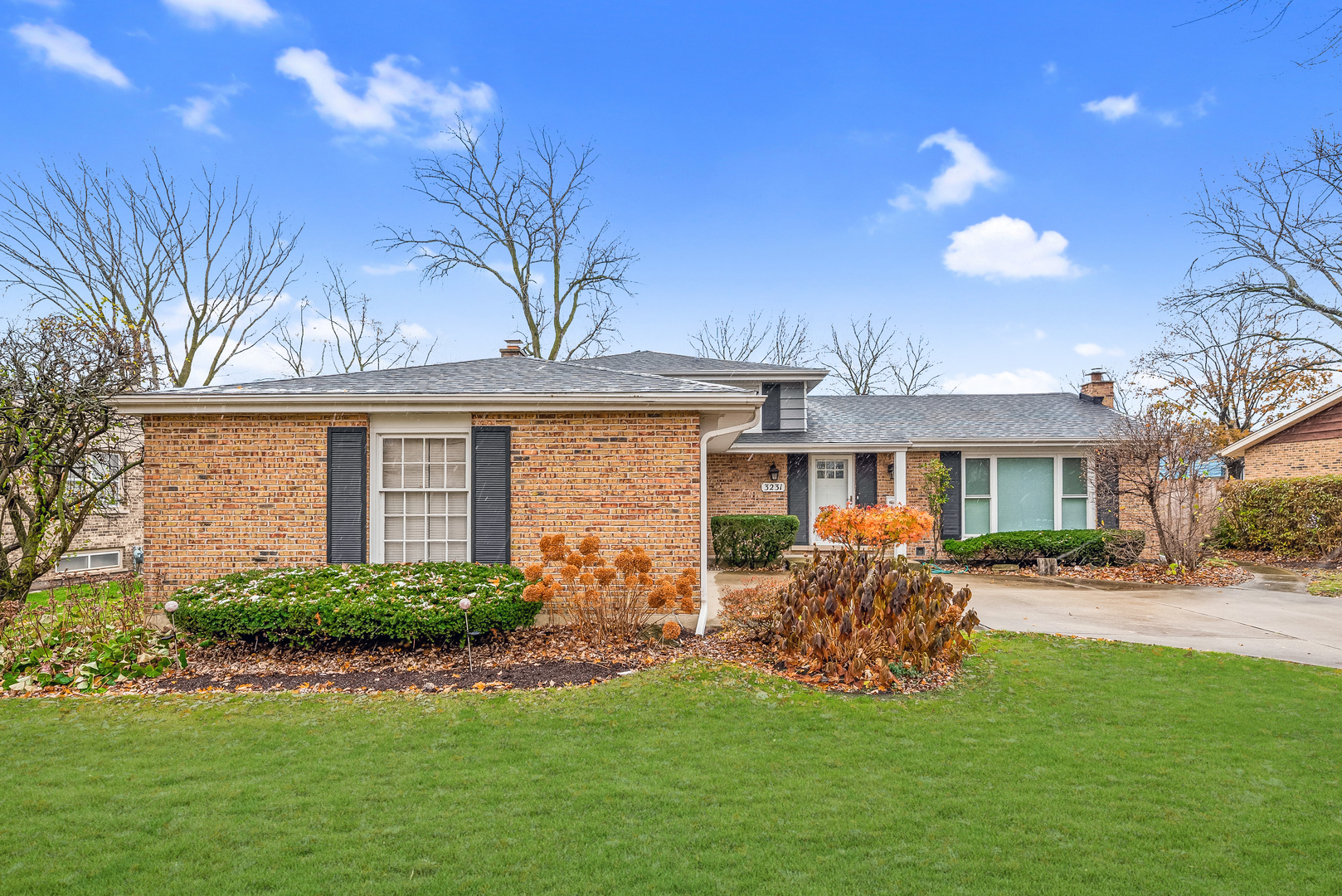 a front view of a house with a garden