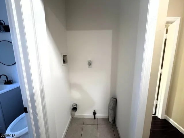 a view of empty room with wooden floor and cabinet