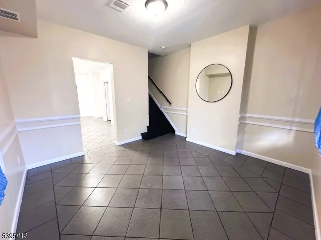 a view of a livingroom with wooden floor and a rug