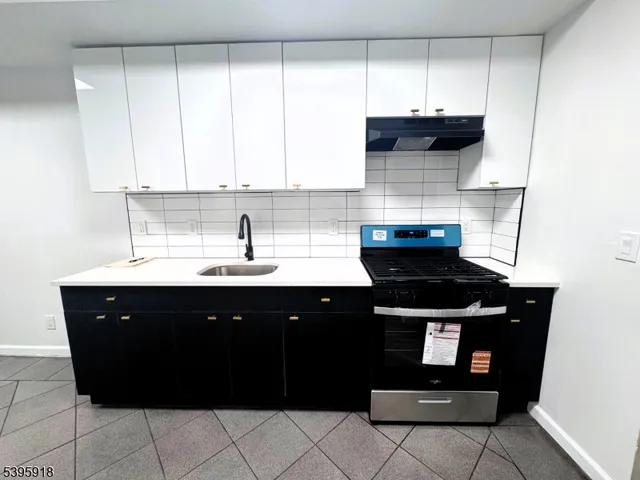 a kitchen with a sink and cabinets