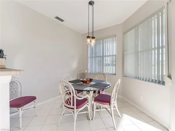 a dining room with furniture and window