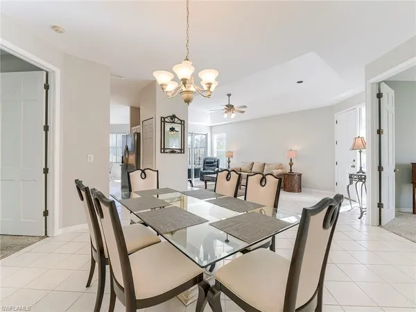 a view of a dining room with furniture and chandelier