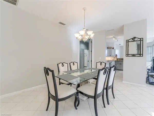 a view of a dining room with furniture and chandelier