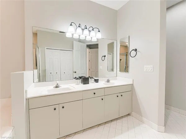 a bathroom with a double vanity sink and a mirror