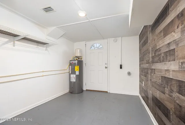 a view of storage and utility room with refrigerator