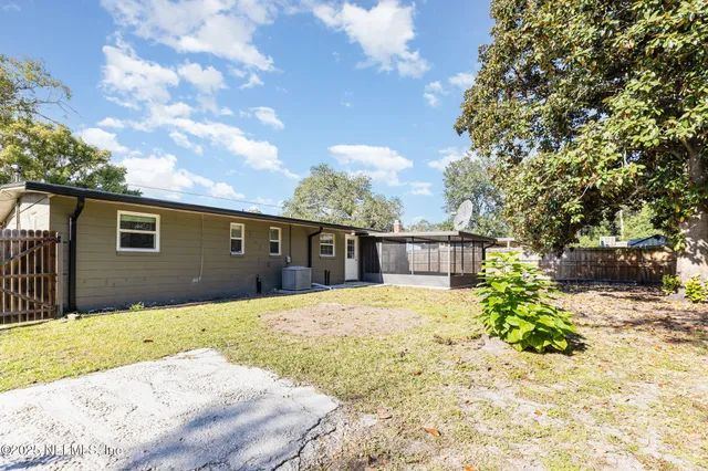 a front view of house along with trees