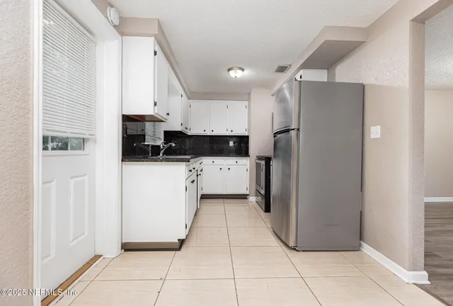 a kitchen with stainless steel appliances a refrigerator sink and cabinets