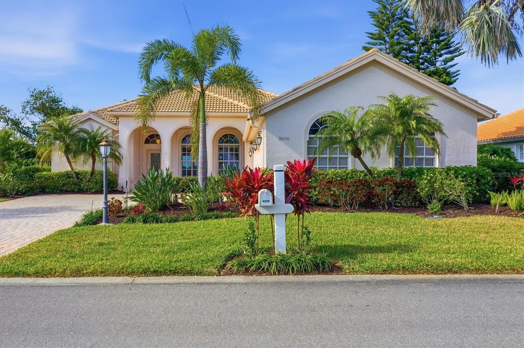 3606 Pennyroyal Road Port Charlotte, FL 33953 - Photo 1 of 96 a front view of yellow house with a yard and potted plants