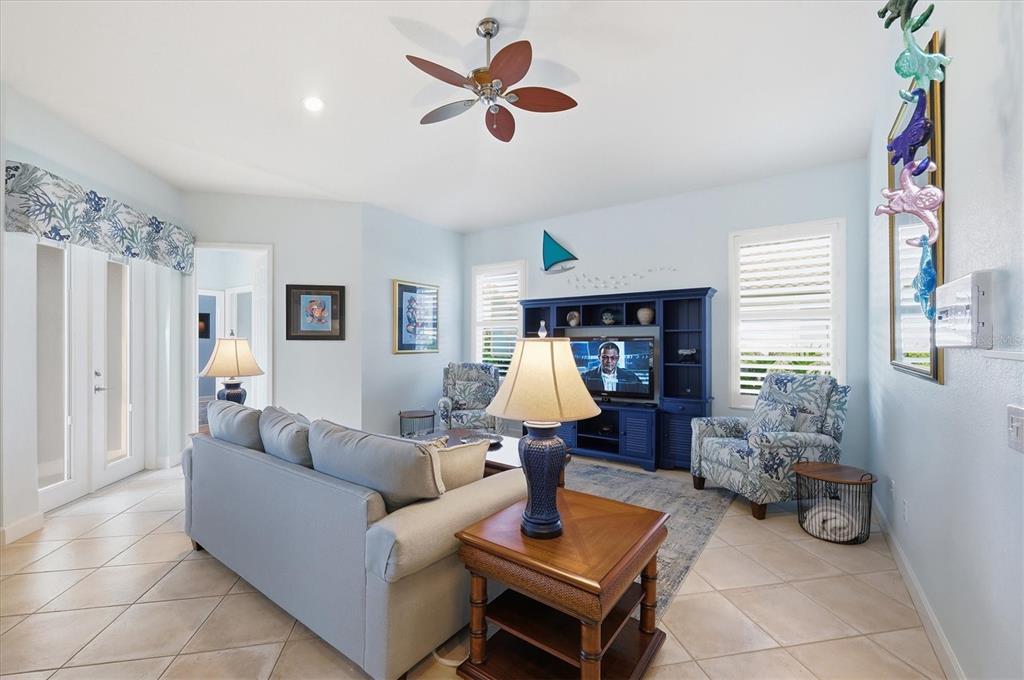 3606 Pennyroyal Road Port Charlotte, FL 33953 - Photo 31 of 96 a living room with furniture and a chandelier