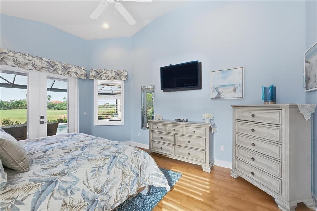 3606 Pennyroyal Road Port Charlotte, FL 33953 - Photo 35 of 96 a spacious bedroom with a bed and a flat screen tv