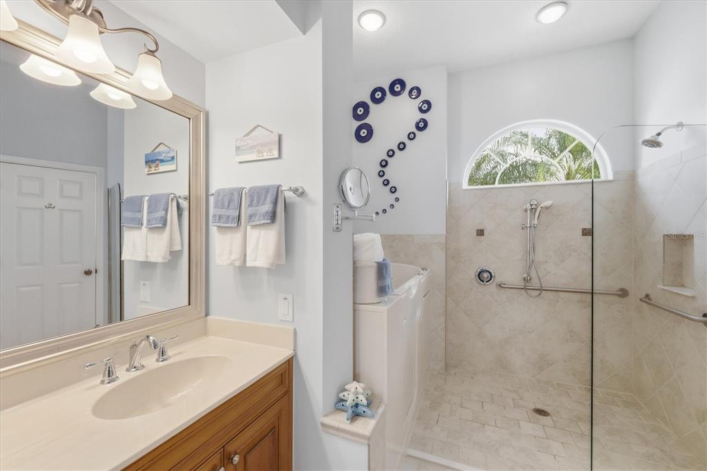3606 Pennyroyal Road Port Charlotte, FL 33953 - Photo 37 of 96 a bathroom with a sink vanity mirror and shower