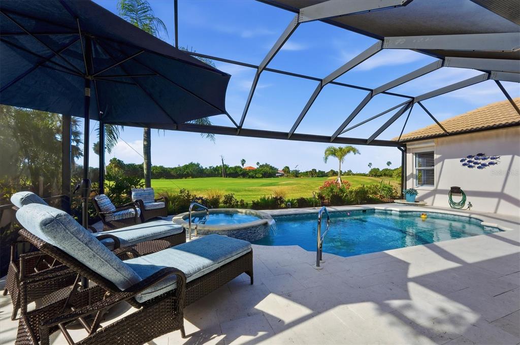 3606 Pennyroyal Road Port Charlotte, FL 33953 - Photo 56 of 96 a view of a patio with a table and chairs under an umbrella