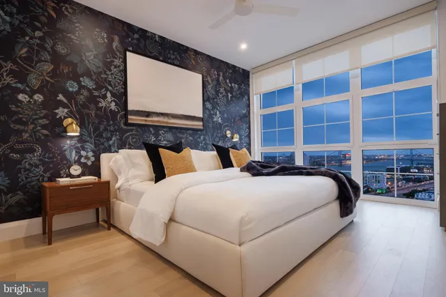 a bed room with a bed and a chair