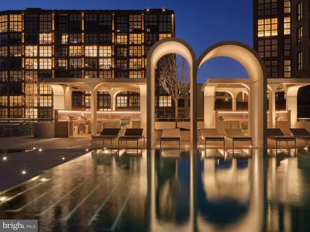 a view of a brick house with a swimming pool