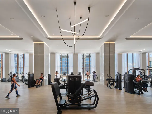 a living room with furniture and floor to ceiling window