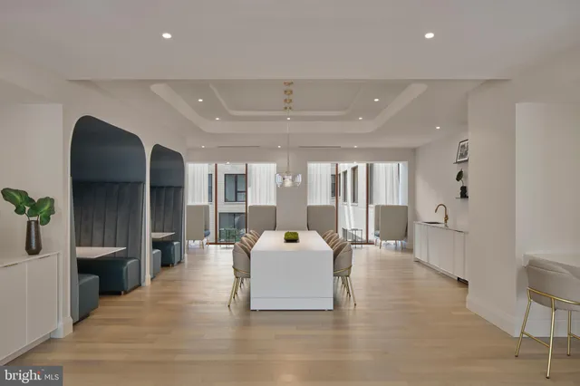 a large room with wooden floor and furniture