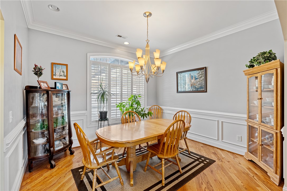 119 Turnberry Road Anderson, SC 29621 - Photo 9 of 50 This bright dining room features rich hardwood flooring and elegant crown molding, perfect for entertaining.