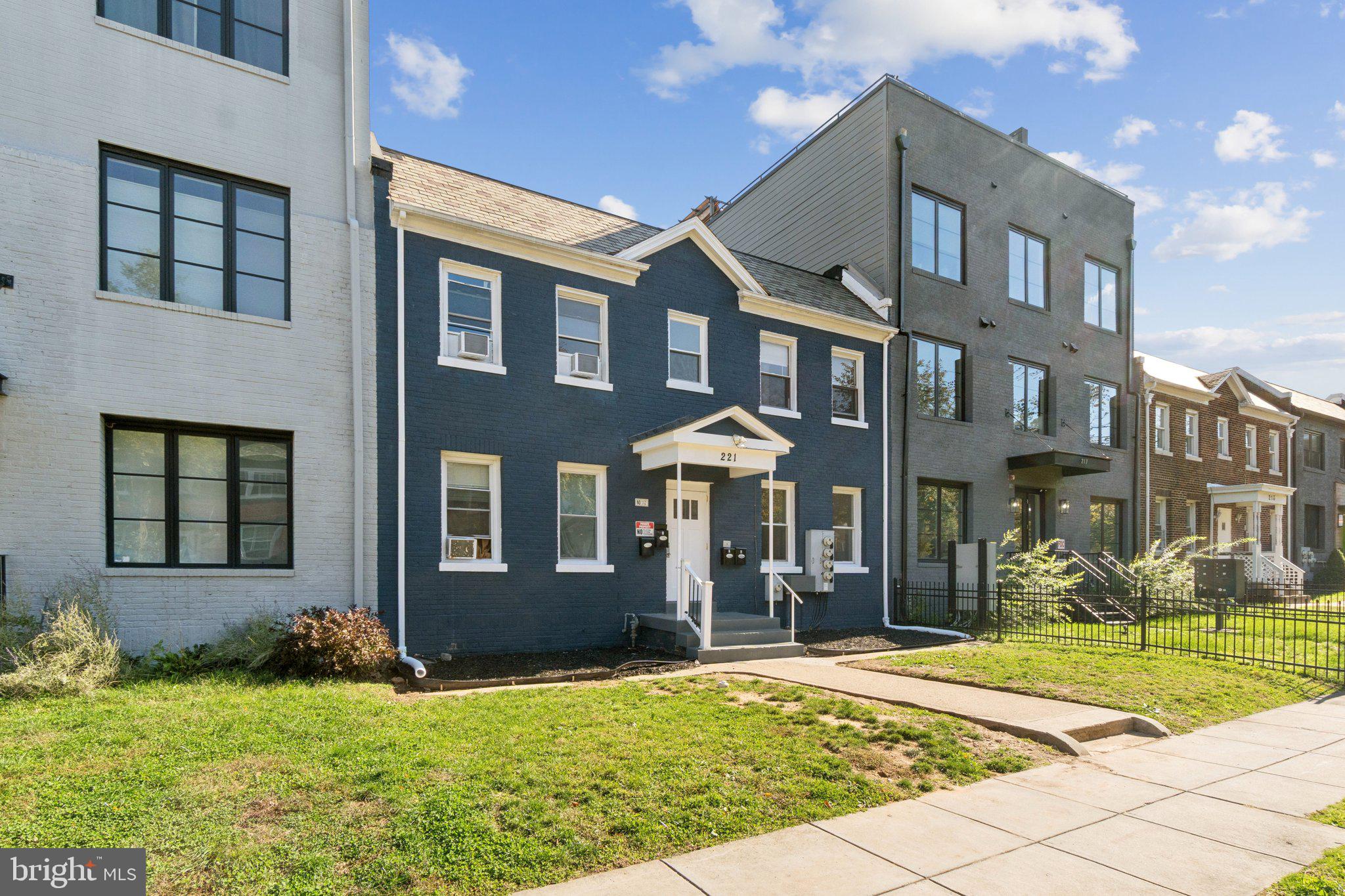 221 20th Street Northeast Washington, DC 20002 - Photo 22 of 26 front view of a brick house with a yard