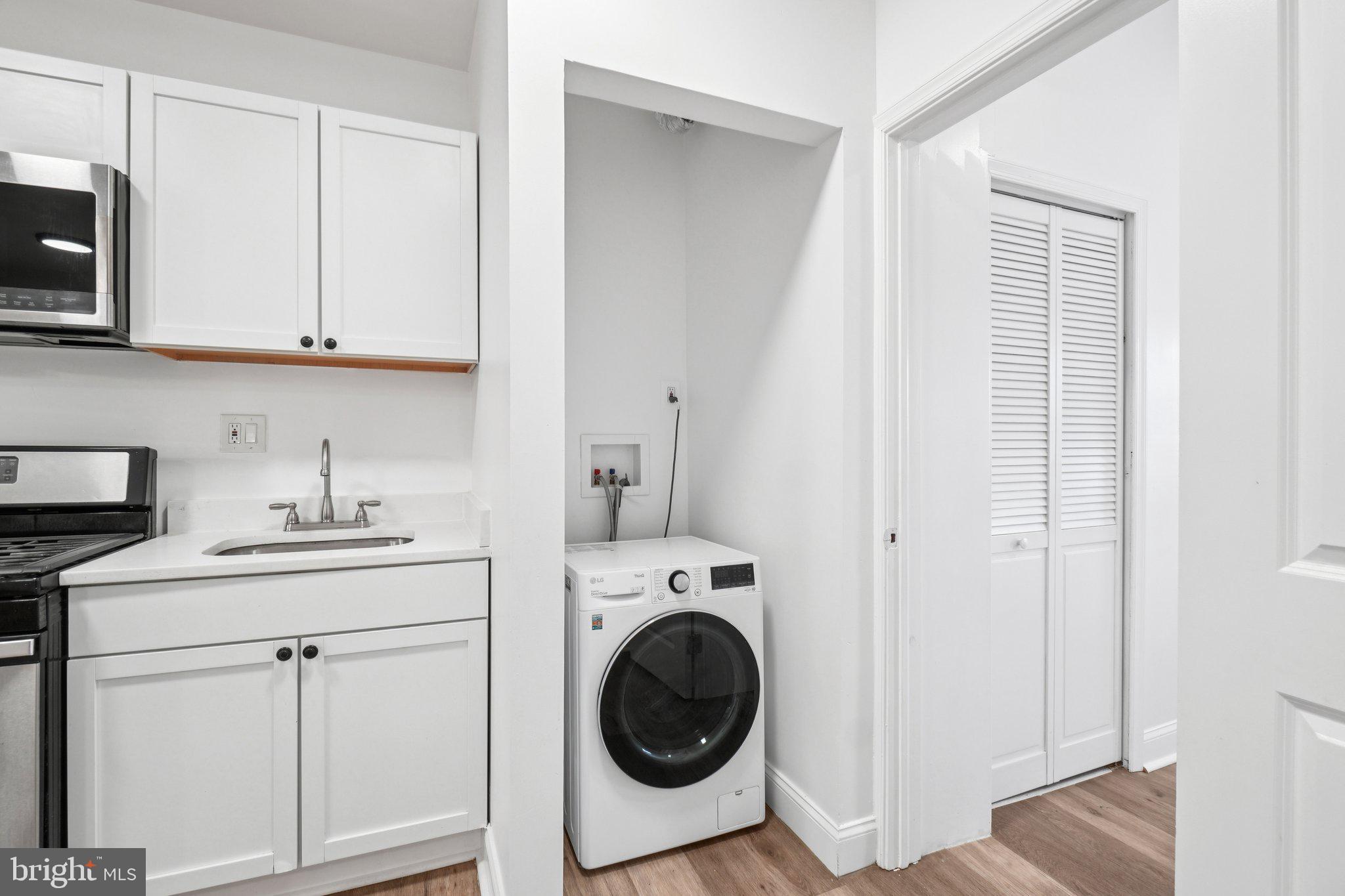221 20th Street Northeast Washington, DC 20002 - Photo 5 of 26 a utility room with sink dryer and washer