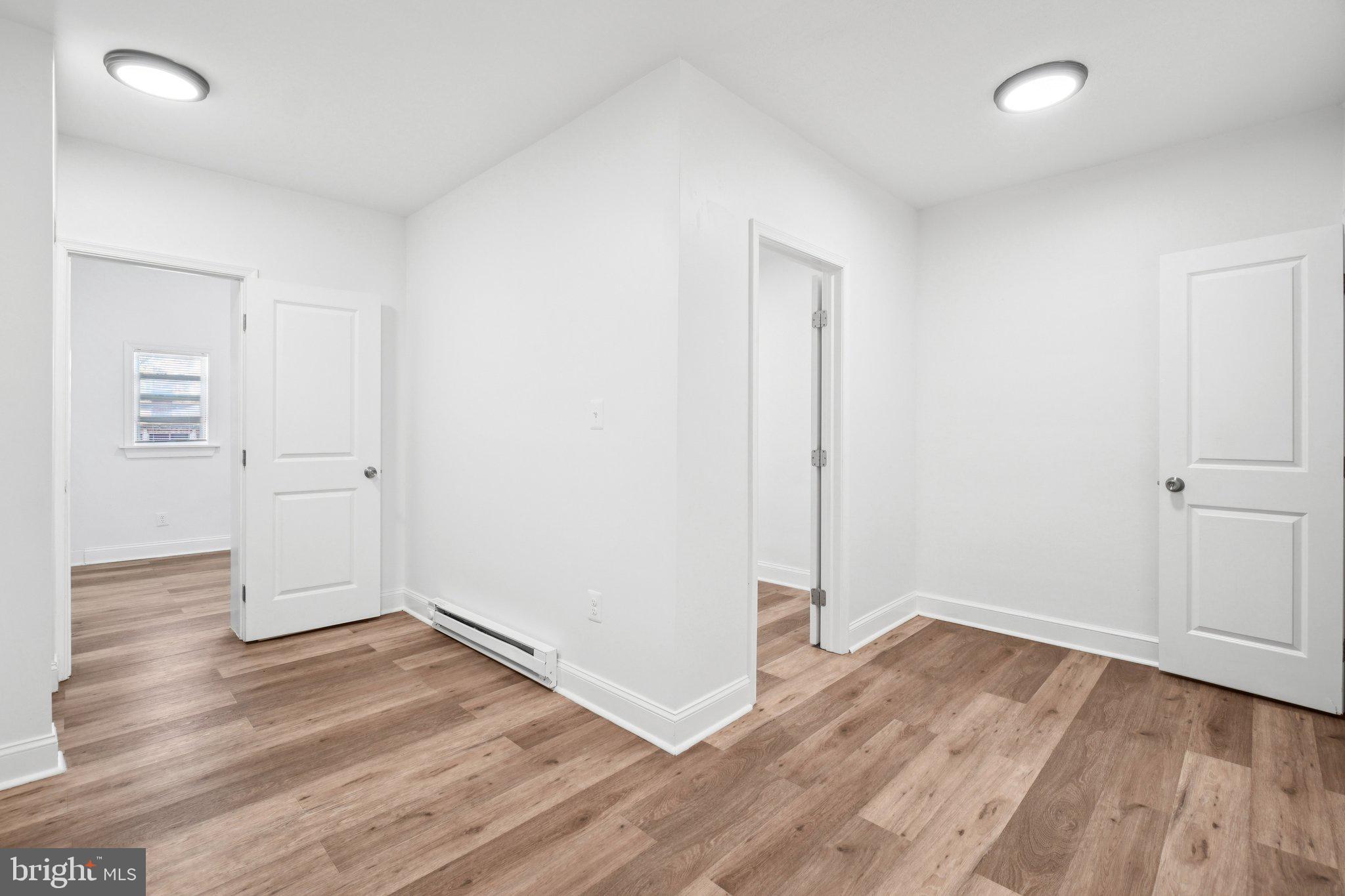 221 20th Street Northeast Washington, DC 20002 - Photo 9 of 26 an empty room with wooden floor & windows