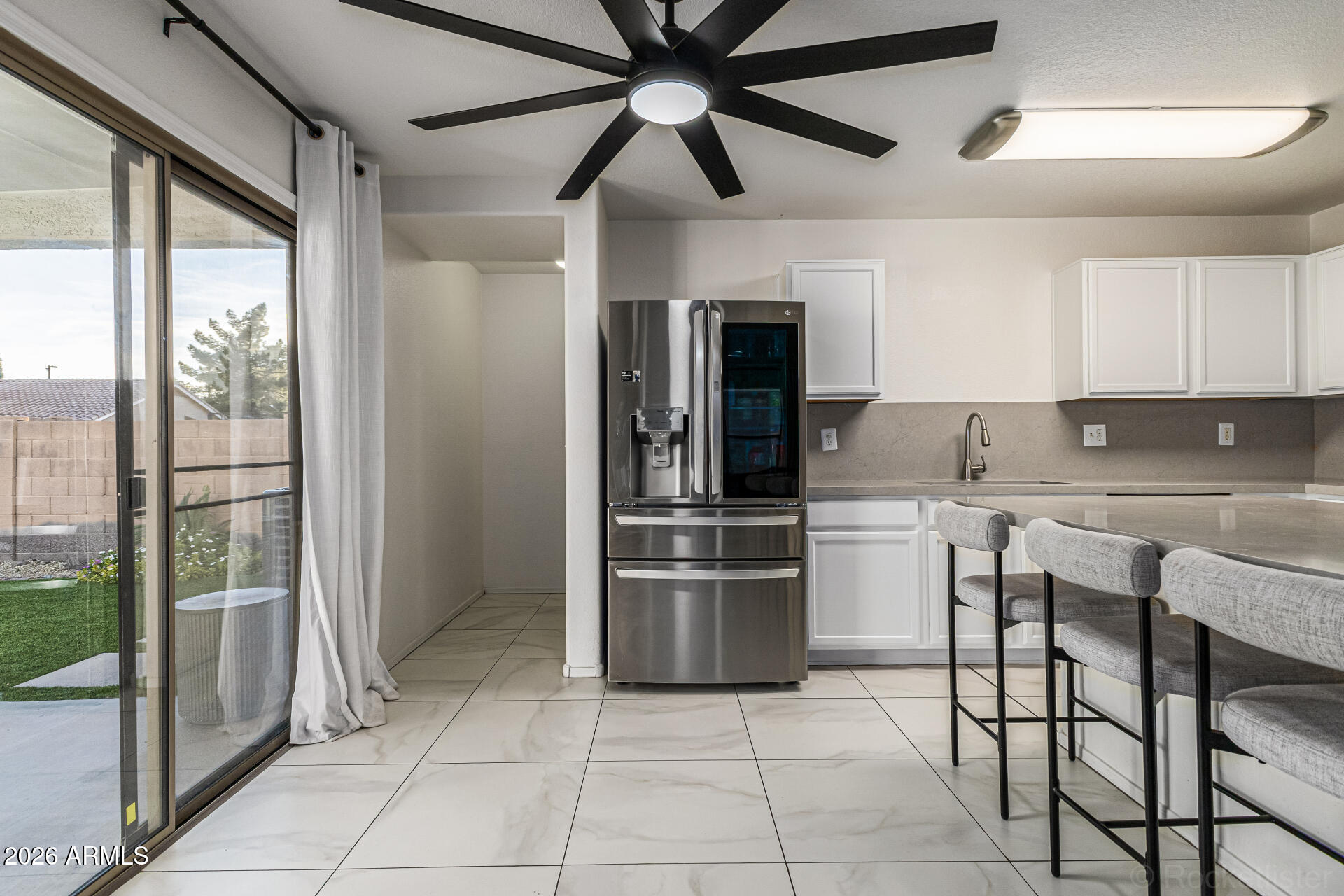3033 East Santa Rosa Drive Gilbert, AZ 85234 - Photo 11 of 24 a kitchen with stainless steel appliances granite countertop a refrigerator and a sink