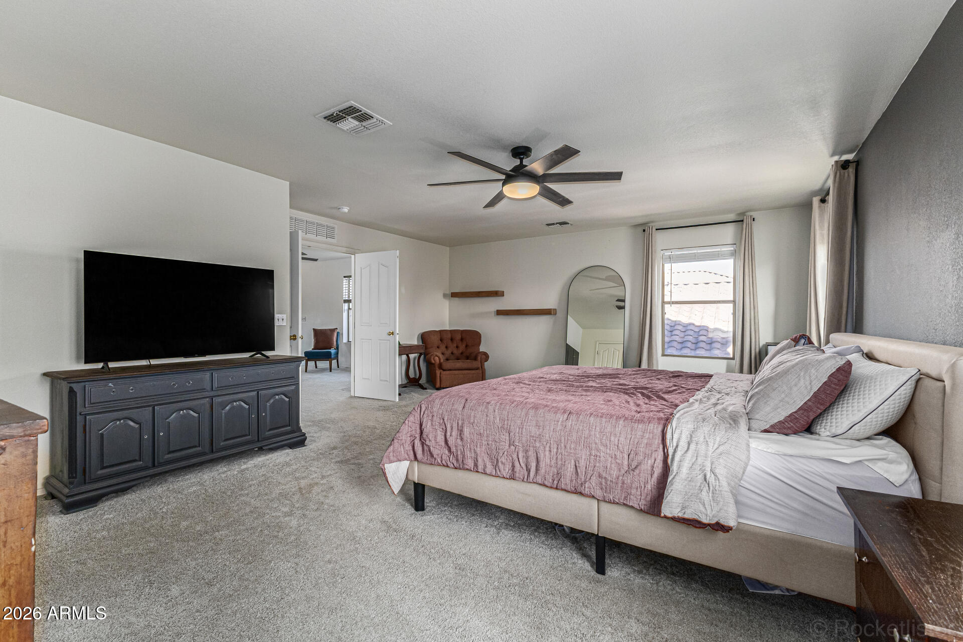 3033 East Santa Rosa Drive Gilbert, AZ 85234 - Photo 12 of 24 a bedroom with a bed and a flat screen tv on dresser