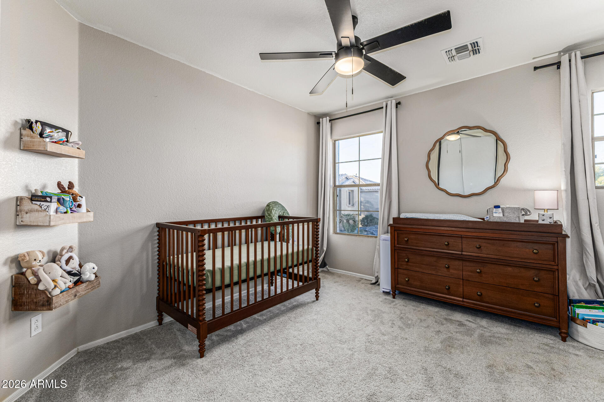 3033 East Santa Rosa Drive Gilbert, AZ 85234 - Photo 19 of 24 a room with a bed and a chandelier