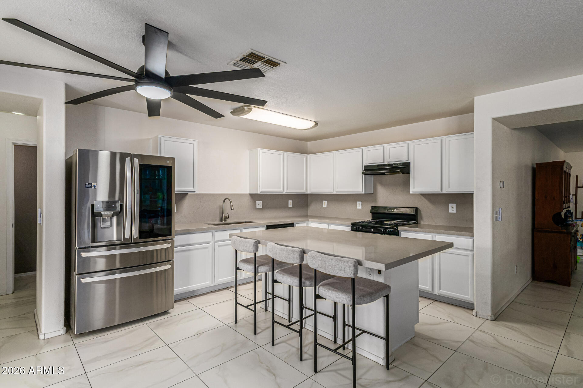 3033 East Santa Rosa Drive Gilbert, AZ 85234 - Photo 2 of 24 a kitchen with a stove a sink and a refrigerator