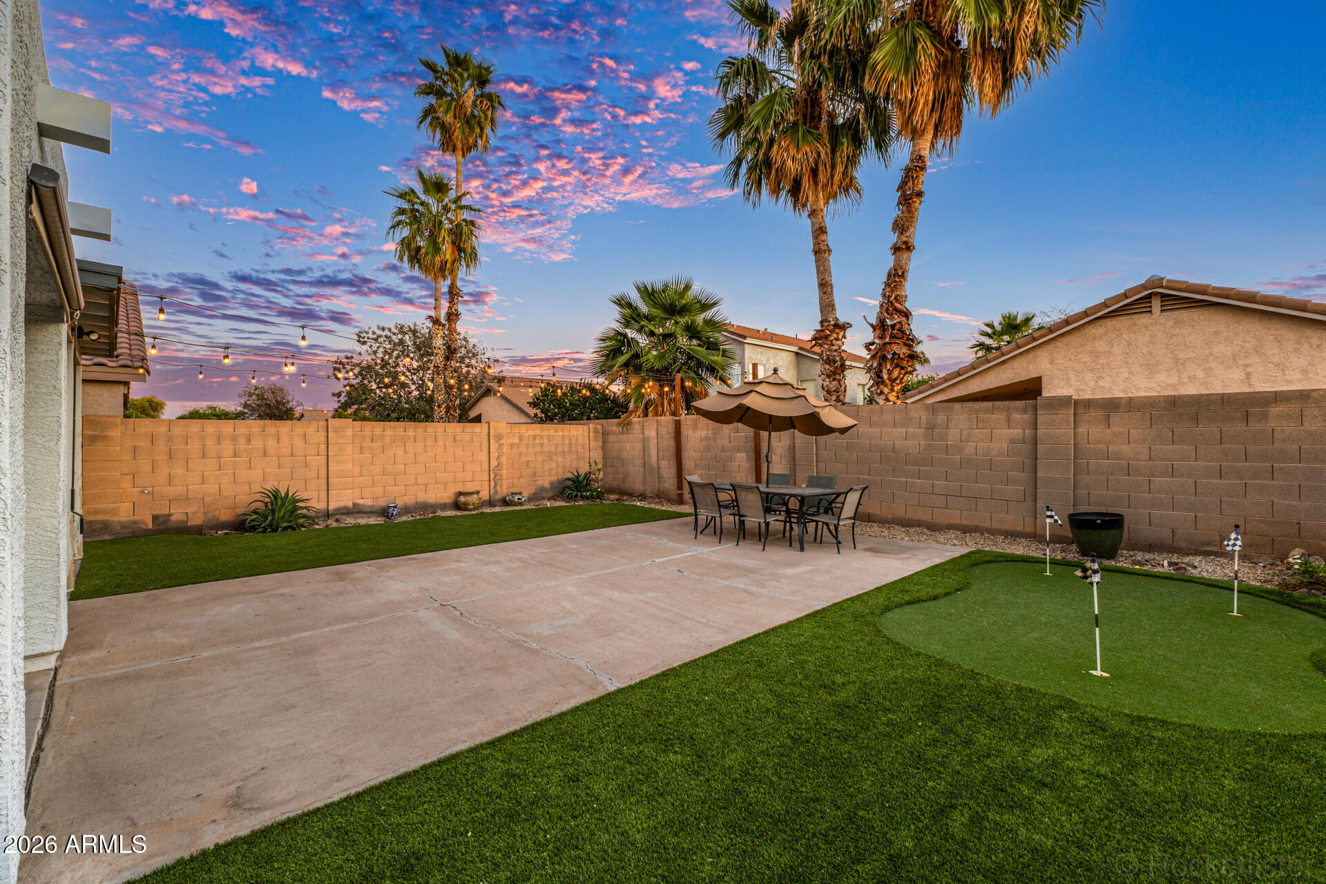 3033 East Santa Rosa Drive Gilbert, AZ 85234 - Photo 5 of 24 a view of a backyard with table and chairs and a slide
