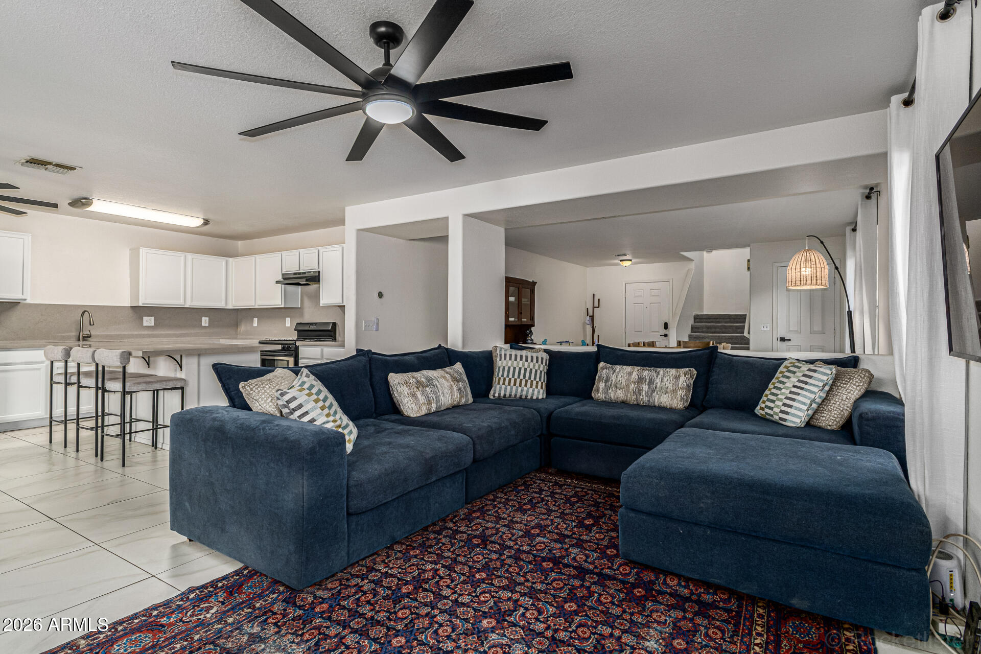 3033 East Santa Rosa Drive Gilbert, AZ 85234 - Photo 9 of 24 a living room with furniture and a view of kitchen