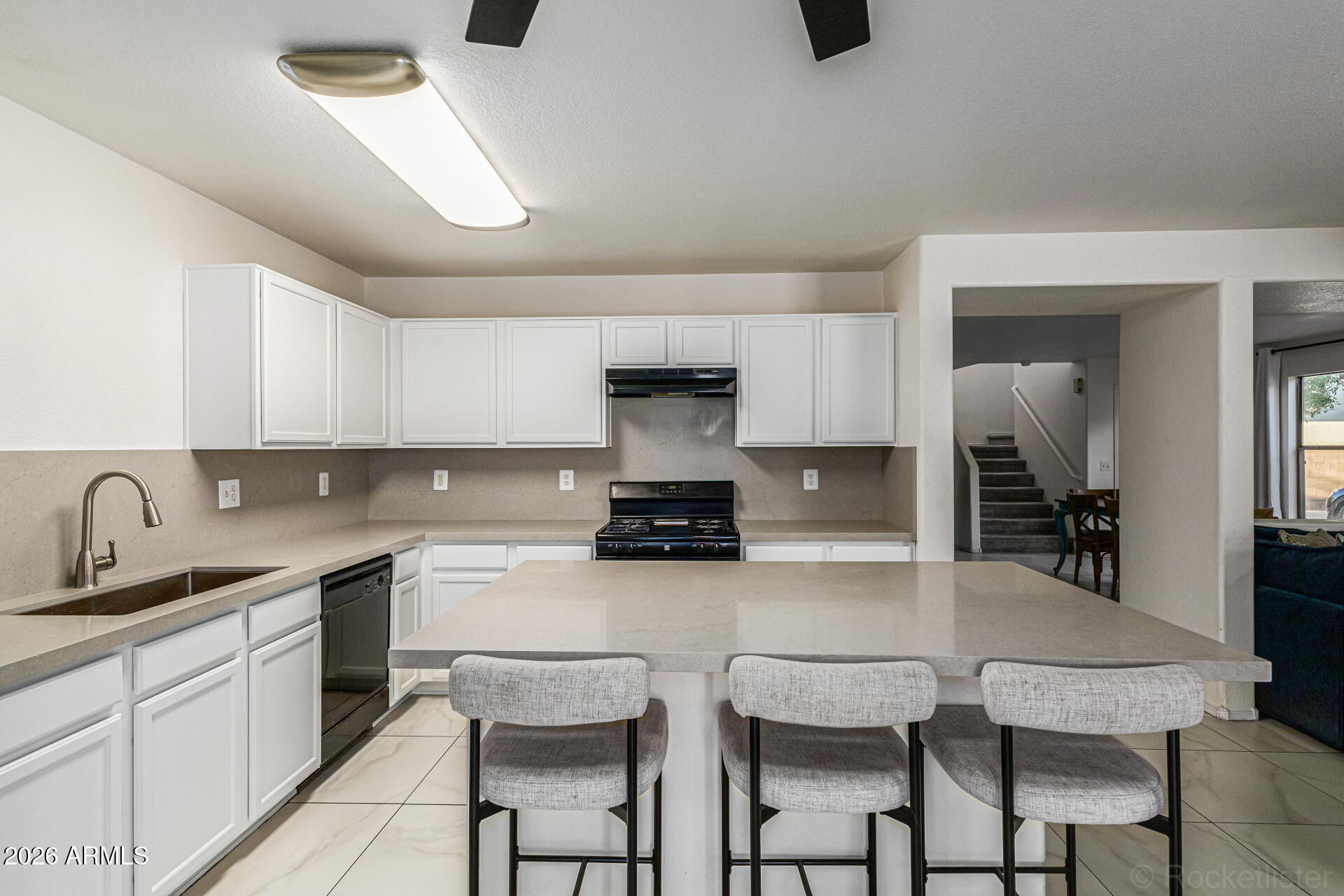3033 East Santa Rosa Drive Gilbert, AZ 85234 - Photo 10 of 24 a kitchen with a table chairs sink and cabinets