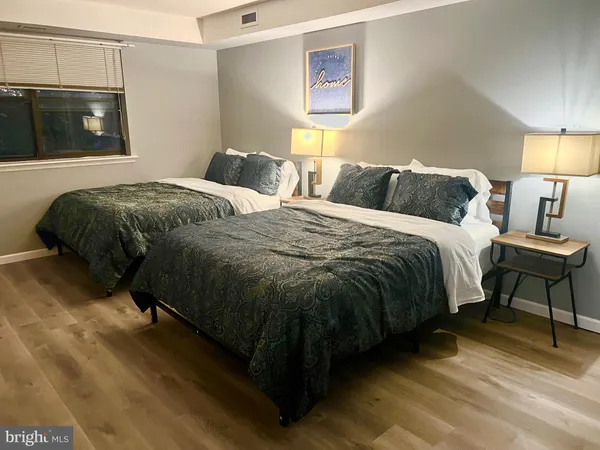 a bedroom with a bed and flat screen tv