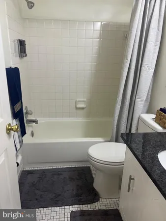 a bathroom with a toilet and a bathtub