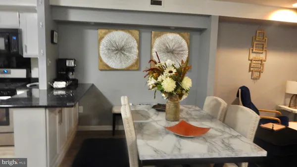 a dining room with furniture and a mirror