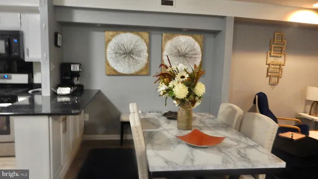 a dining room with furniture and a mirror