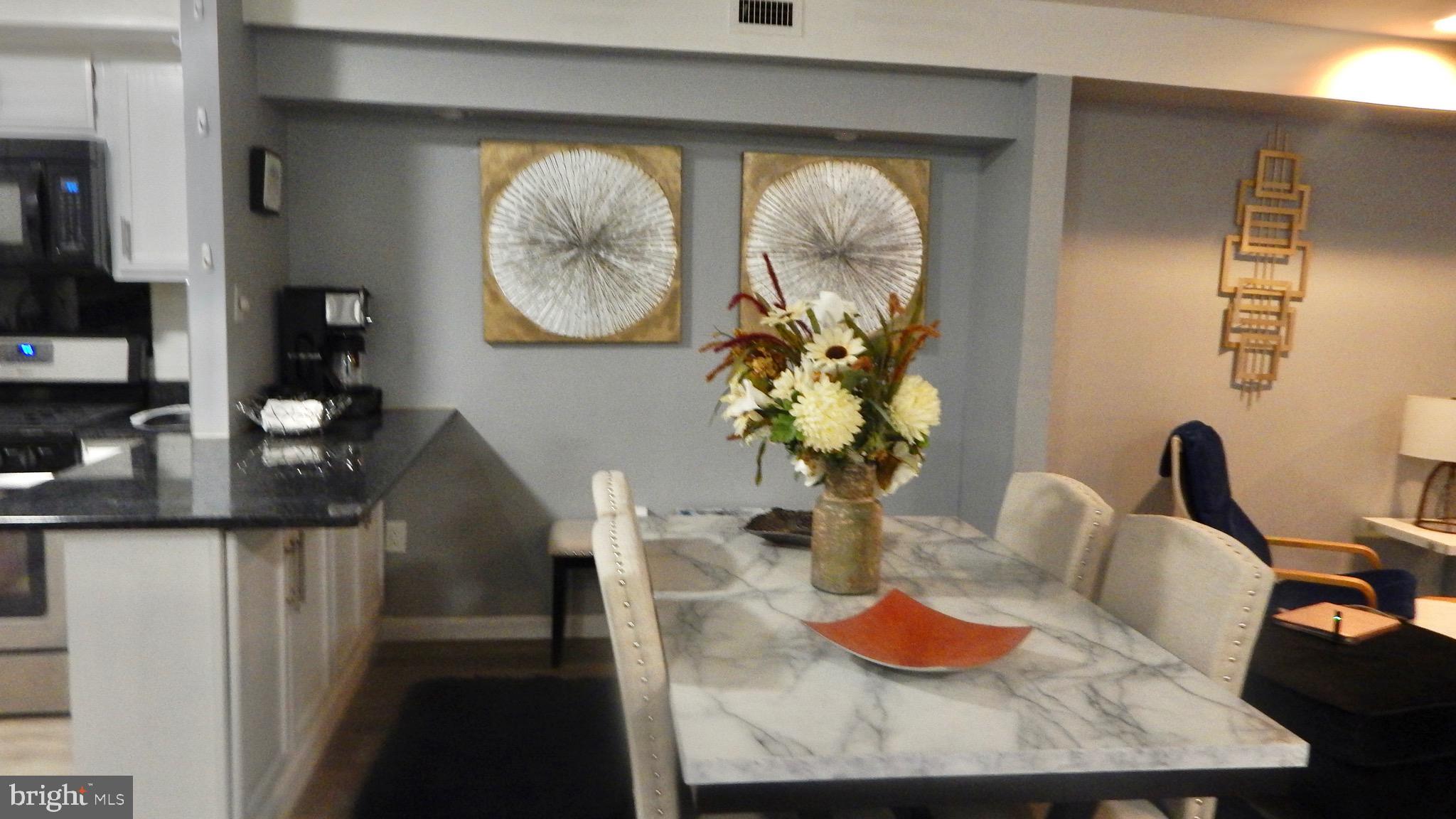 16 Township Line Road Elkins Park, PA 19027 - Photo 21 of 28 a dining room with furniture and a mirror