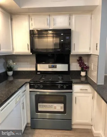 a stove top oven sitting inside of a kitchen