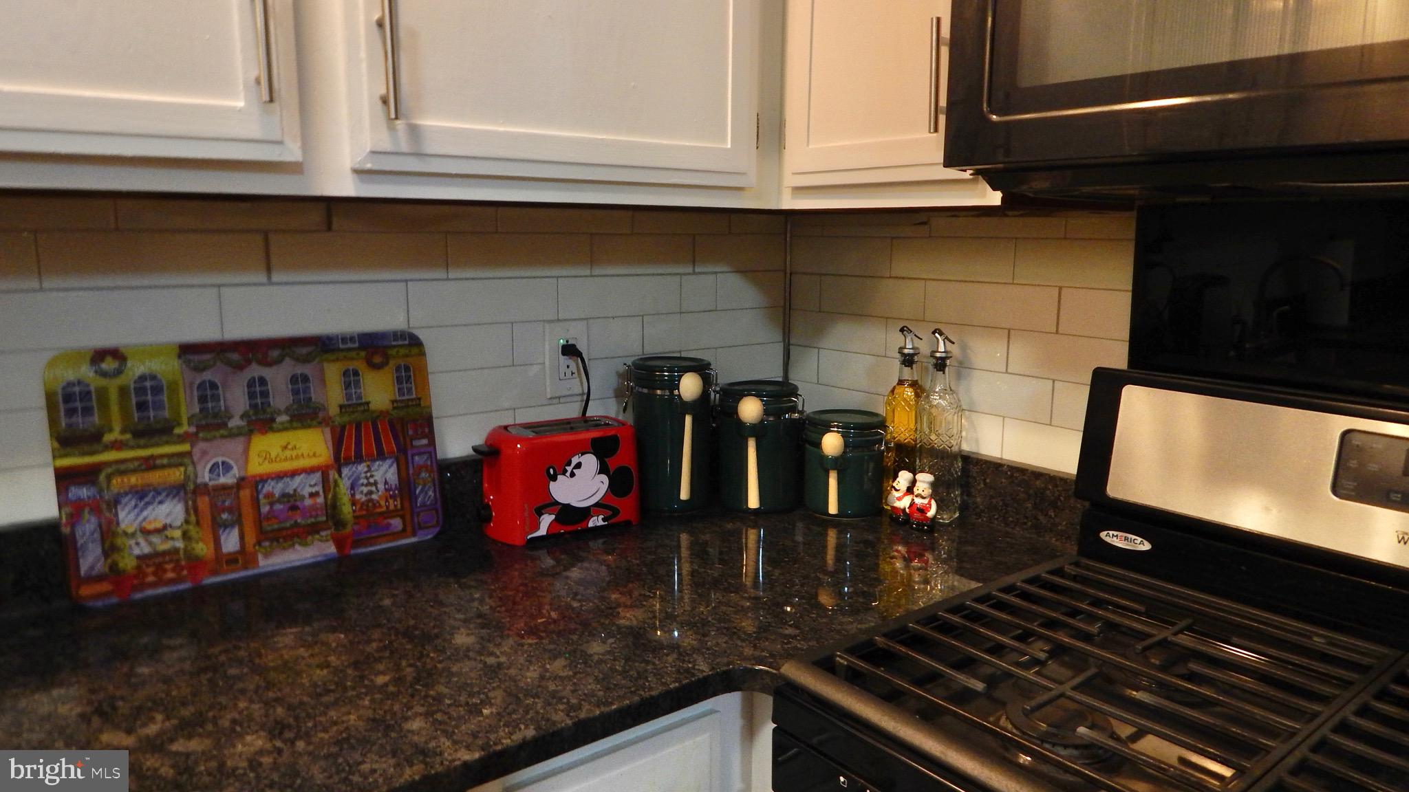 16 Township Line Road Elkins Park, PA 19027 - Photo 23 of 28 a kitchen with an oven a stove and a sink with granite countertops