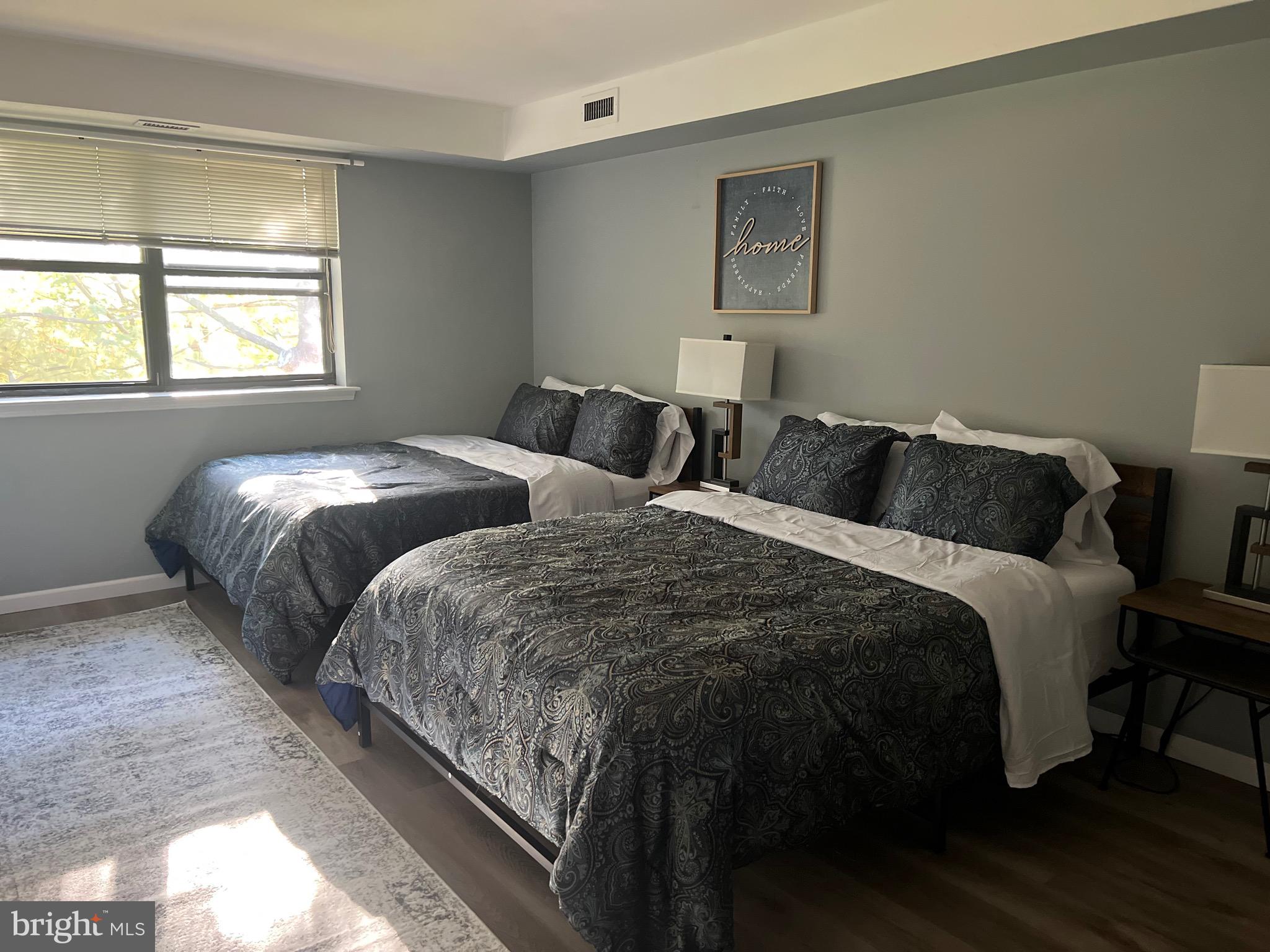 16 Township Line Road Elkins Park, PA 19027 - Photo 8 of 28 a bedroom with two beds and a window