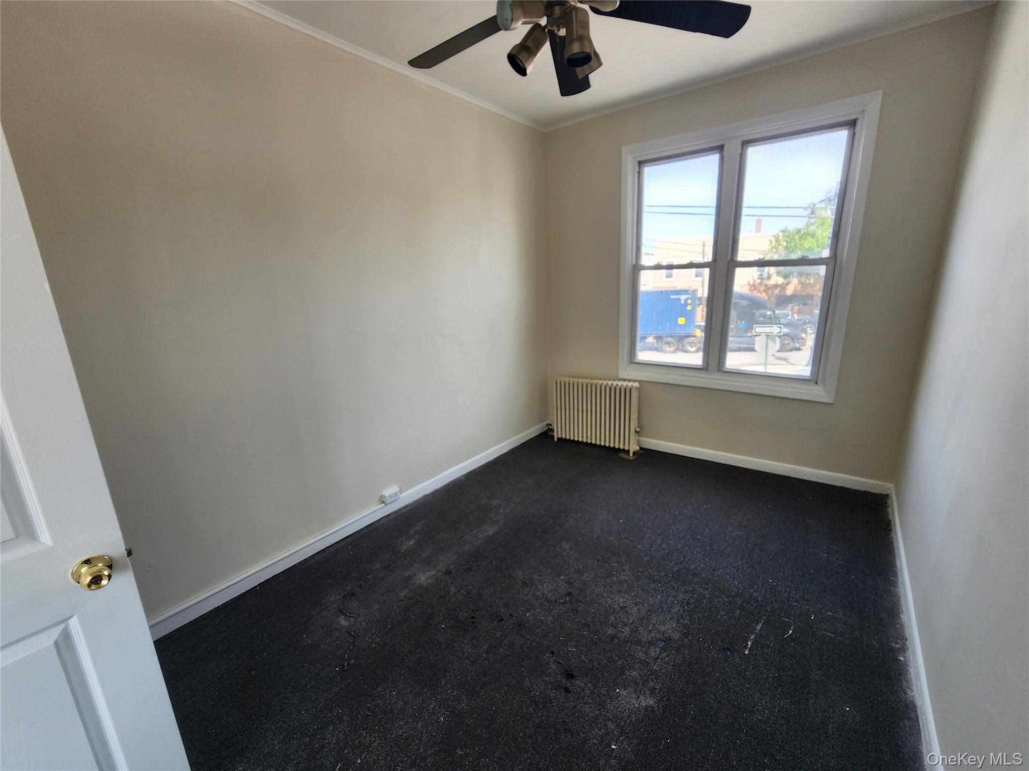59-12 58th Road Queens, NY 11378 - Photo 11 of 21 a view of an empty room with a window