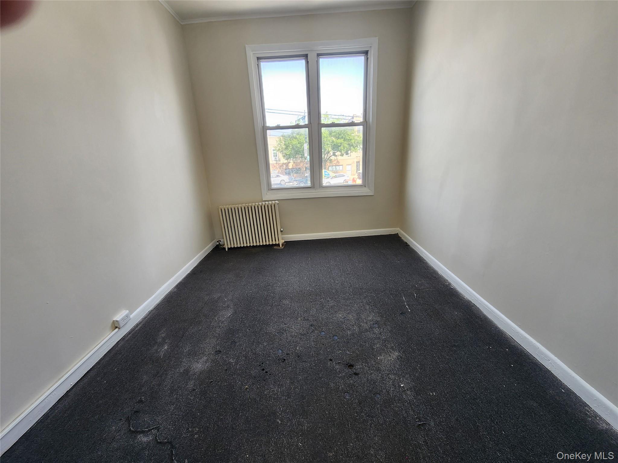 59-12 58th Road Queens, NY 11378 - Photo 19 of 21 an empty room with a window