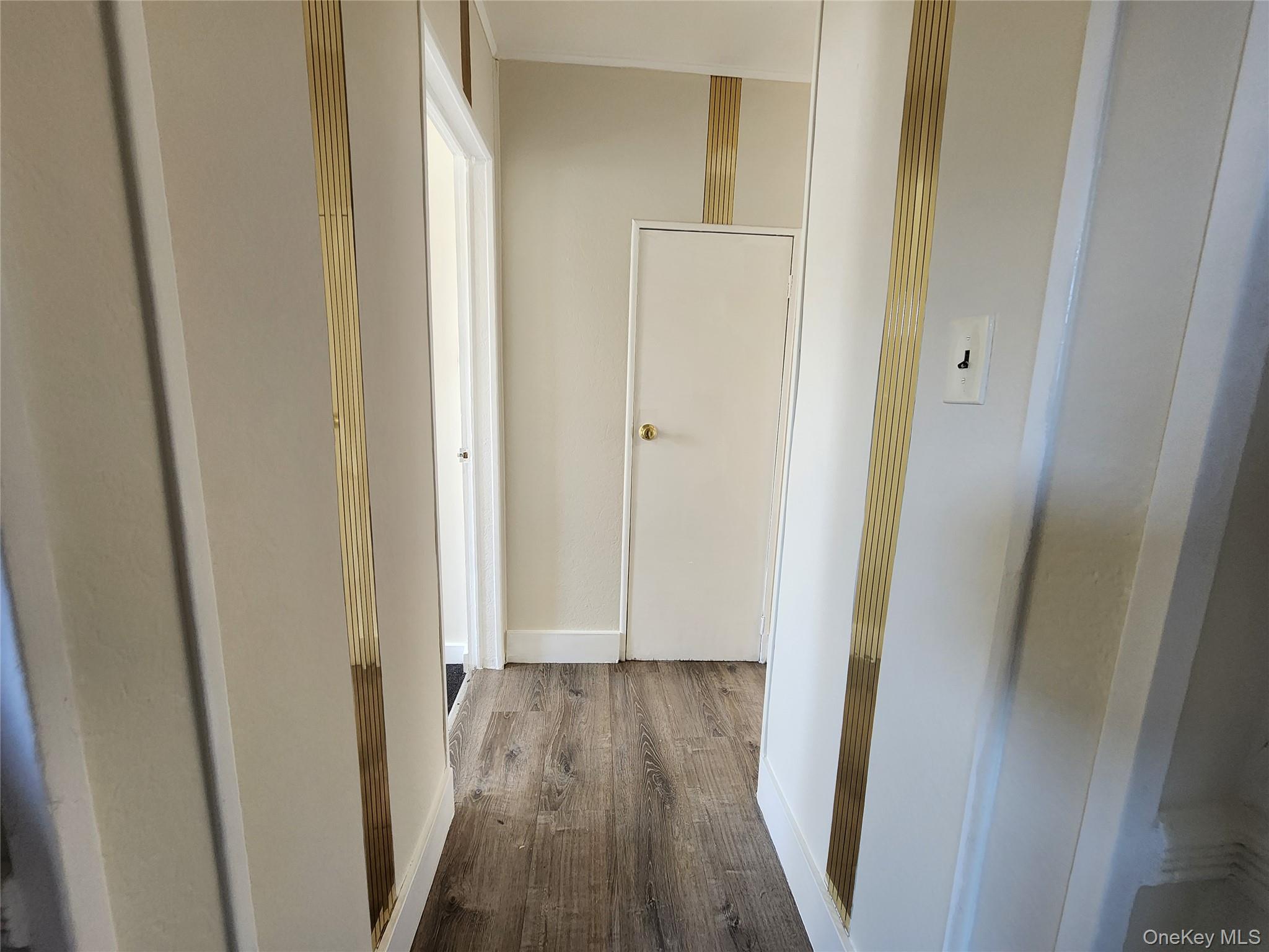 59-12 58th Road Queens, NY 11378 - Photo 21 of 21 a view of a hallway with wooden floor