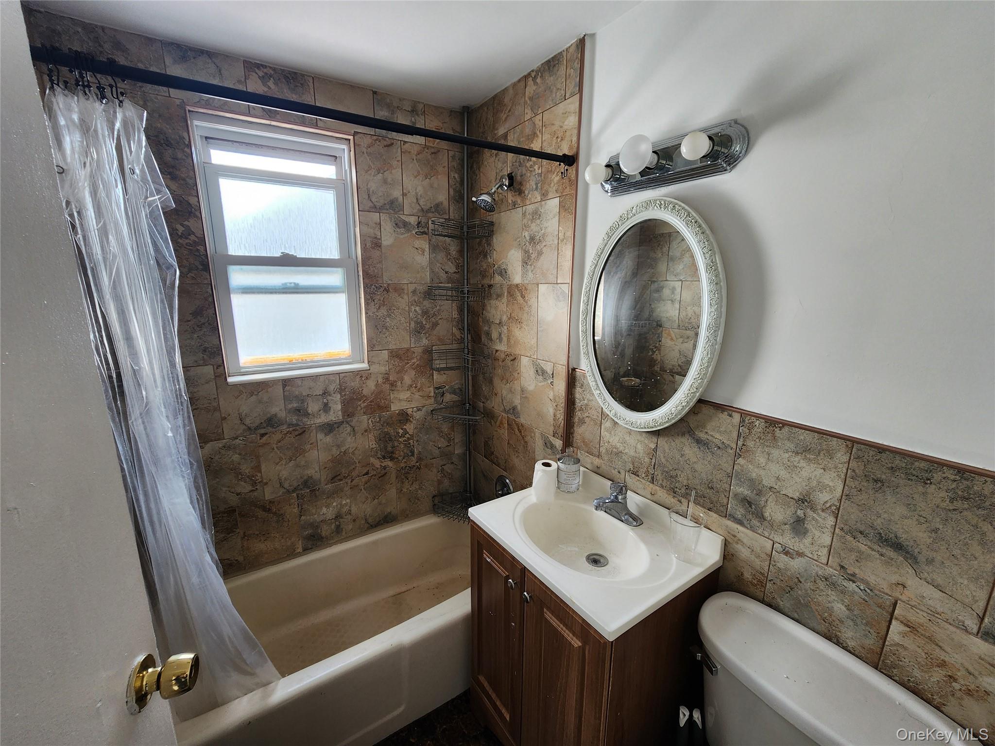 59-12 58th Road Queens, NY 11378 - Photo 7 of 21 a bathroom with a sink toilet and shower