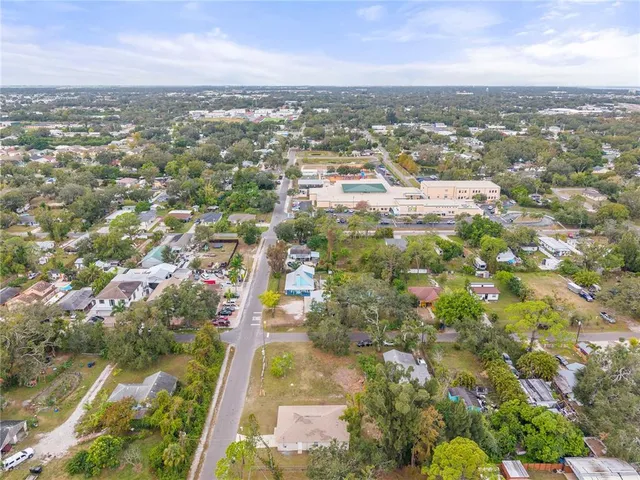 an aerial view of lake and residential houses with outdoor space