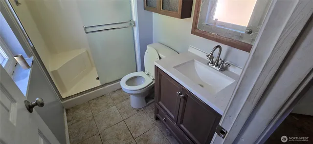 a bathroom with a sink and mirror with toilet